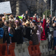 Protesters cheer in support of a speaker.